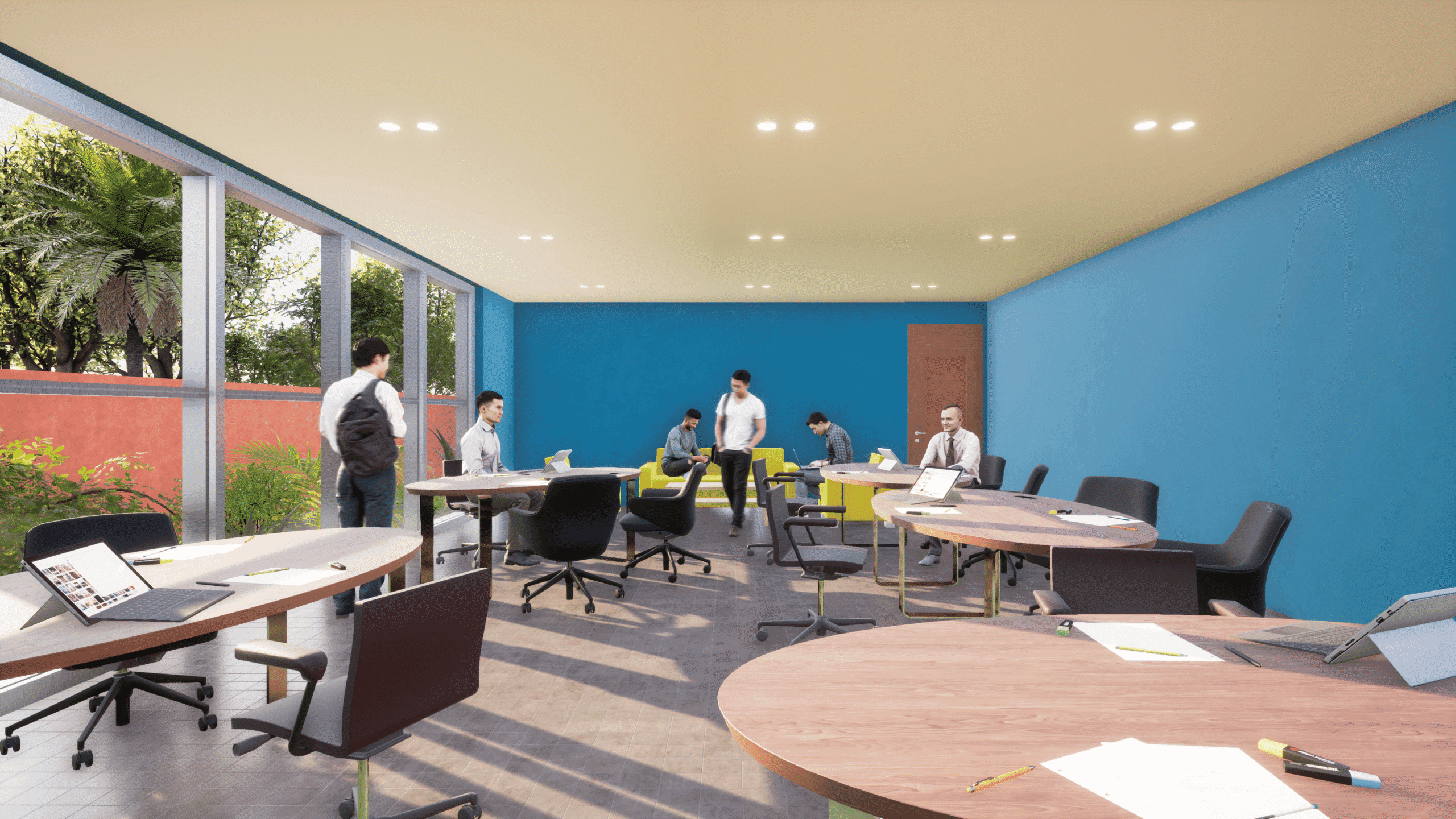 Un bureau moderne, bien éclairé, avec des murs bleus, des tables rondes, des chaises éparpillées et plusieurs personnes qui travaillent ou discutent. De grandes fenêtres laissent apparaître de la verdure à l'extérieur. Des ordinateurs portables et des documents sont posés sur les tables.